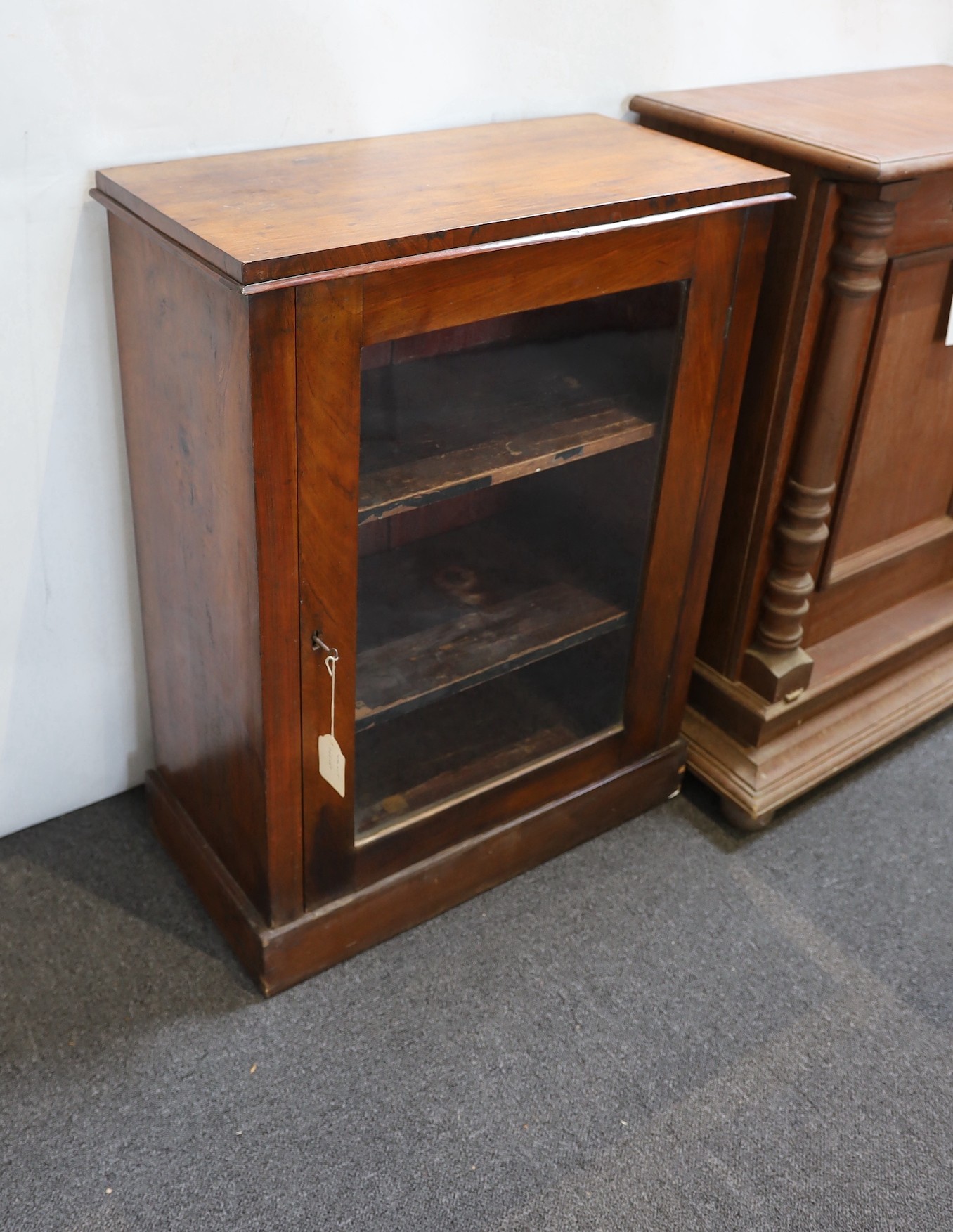 A mahogany Polyphon cabinet base housing approximately 20 19.5 inch discs and a Victorian walnut bookcase.